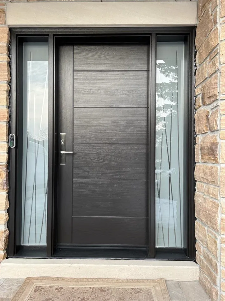 Black front door with glass sidelites set in a brick wall
